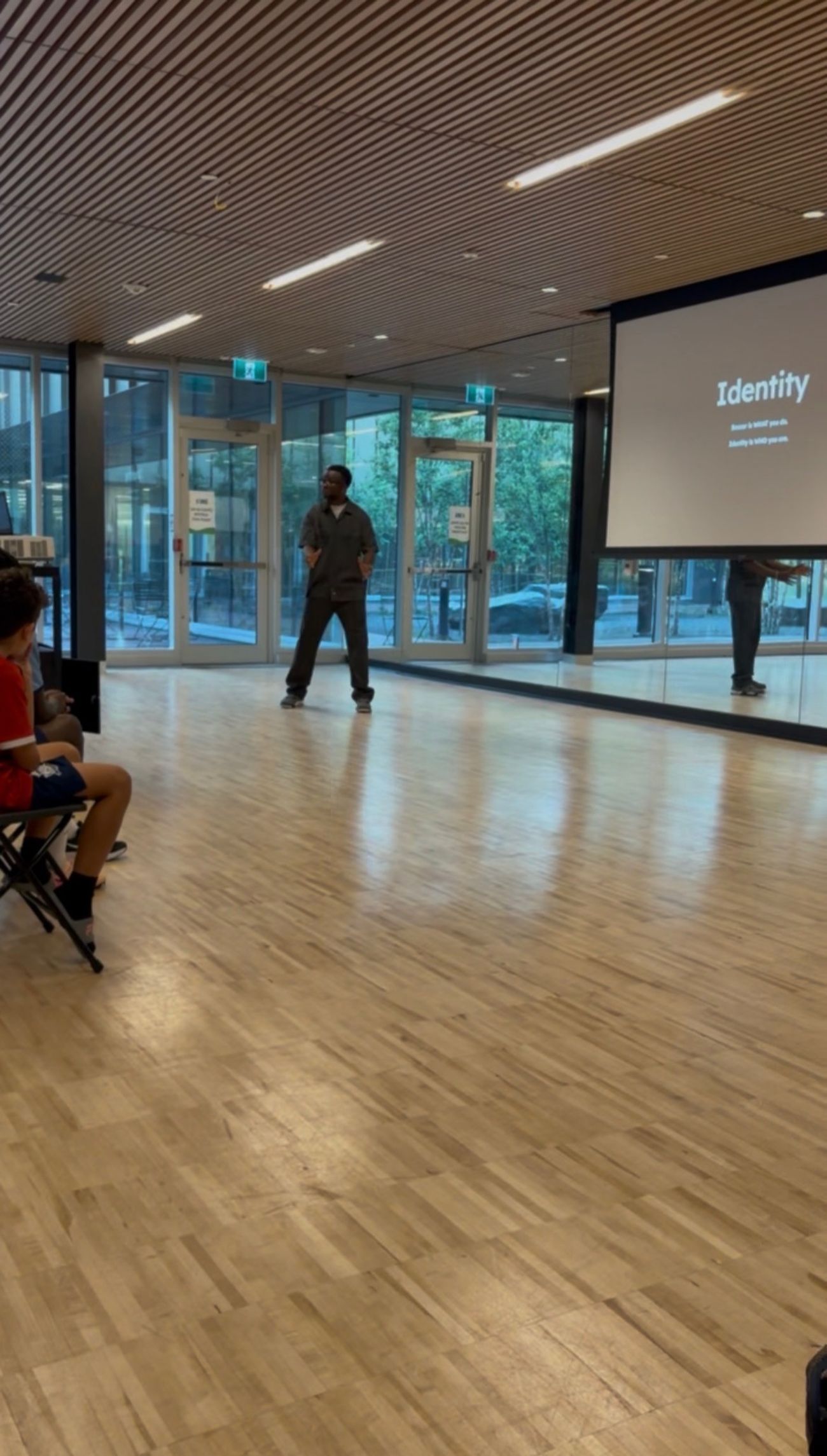 Habib leading a Militérian Mind seminar with a slideshow titled Identity