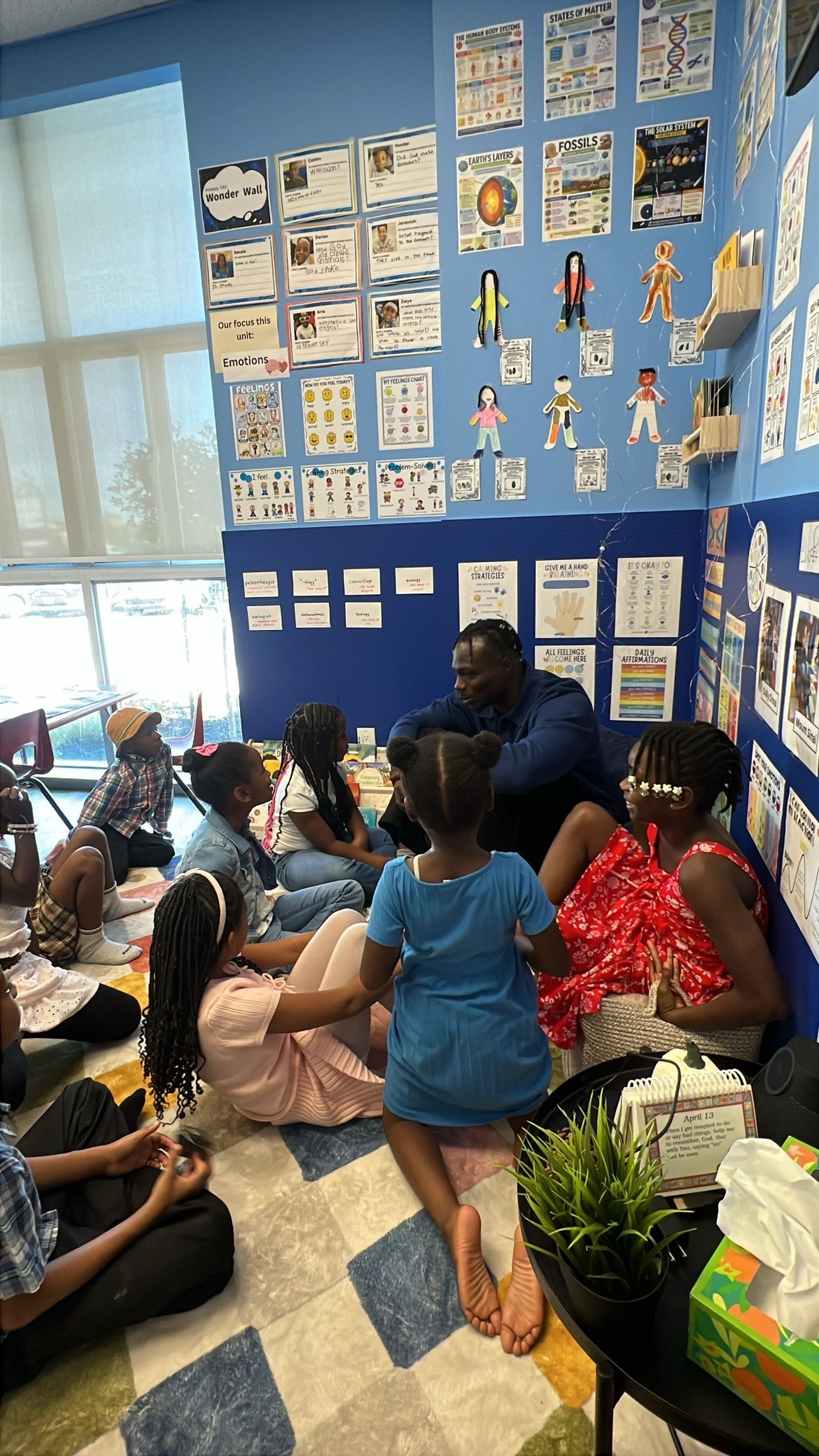 Promise David speaking with a group of children about the Militérian mindset