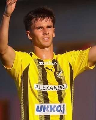 Joshua Pulla celebrating in a yellow and black club kit